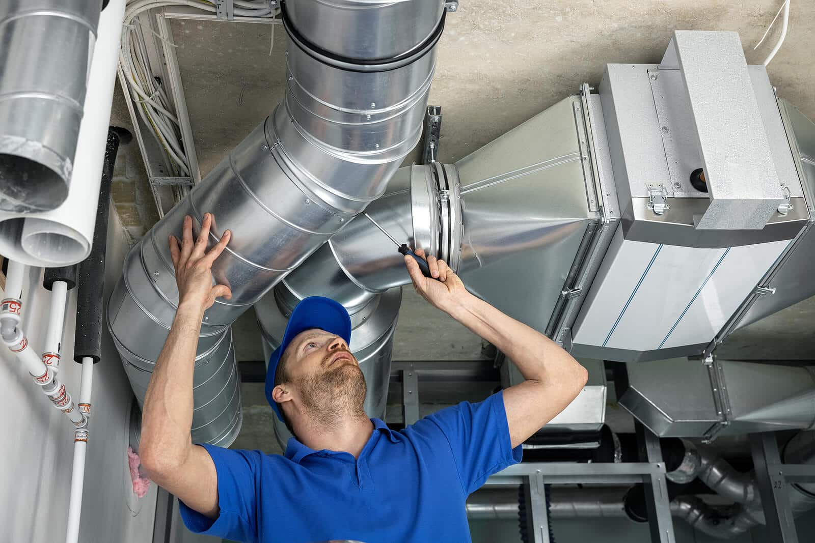 HVAC technician inspecting and repairing air ducts in Folsom