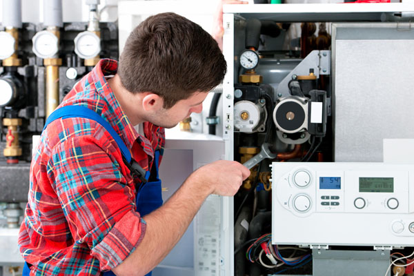 Heating technician repairing boiler controls in Folsom