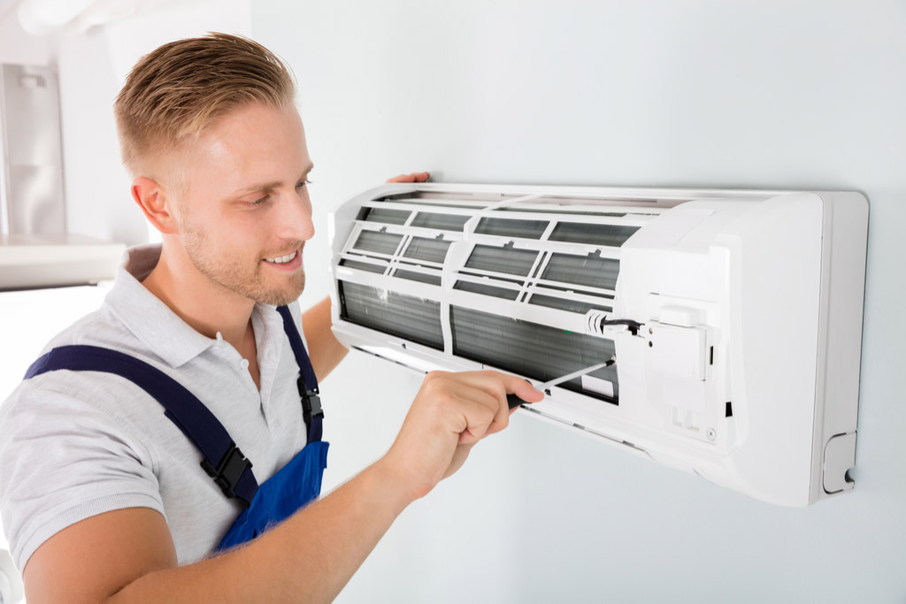 HVAC technician maintaining a ductless air conditioner in Folsom