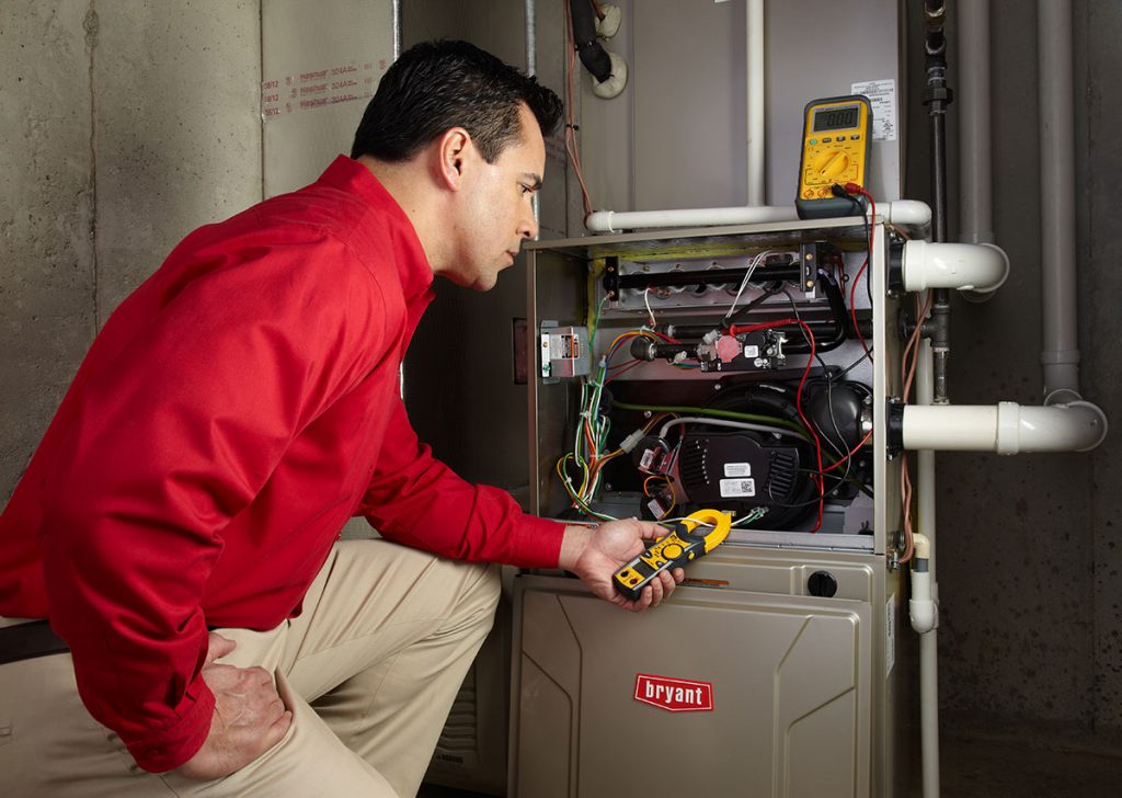 Heating technician diagnosing a furnace repair in Folsom