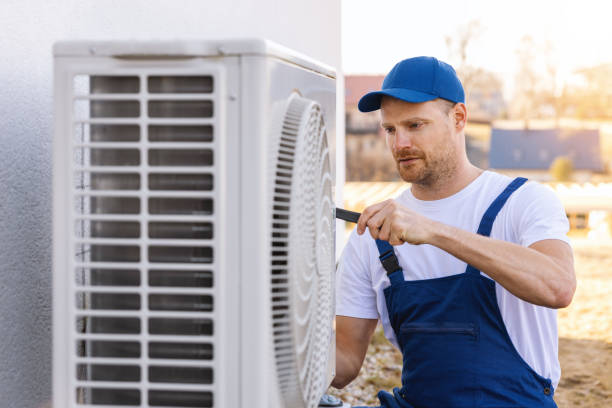 HVAC technician servicing an outdoor air conditioner in Folsom