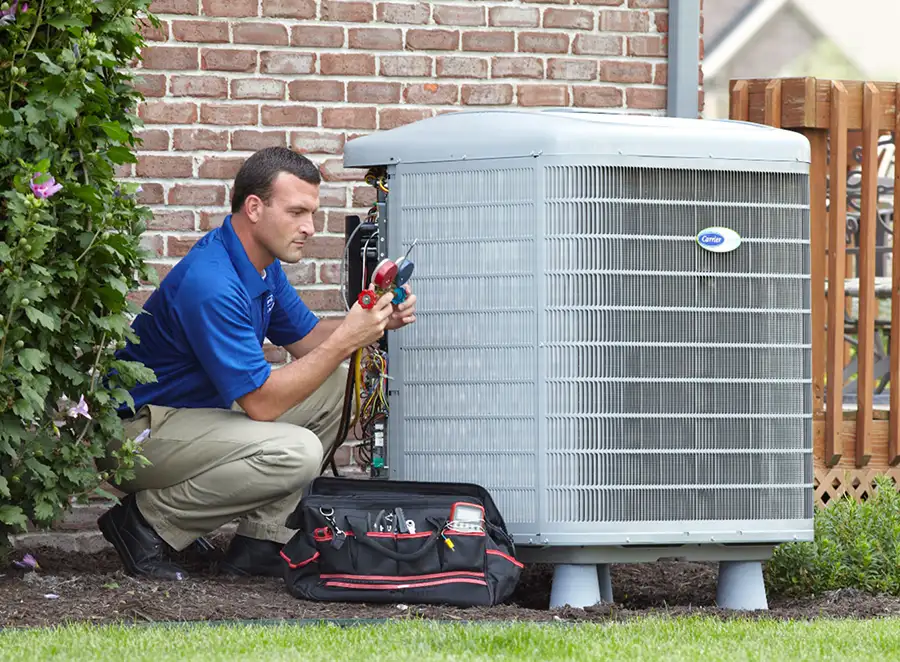 HVAC technician inspecting an outdoor AC unit in Folsom